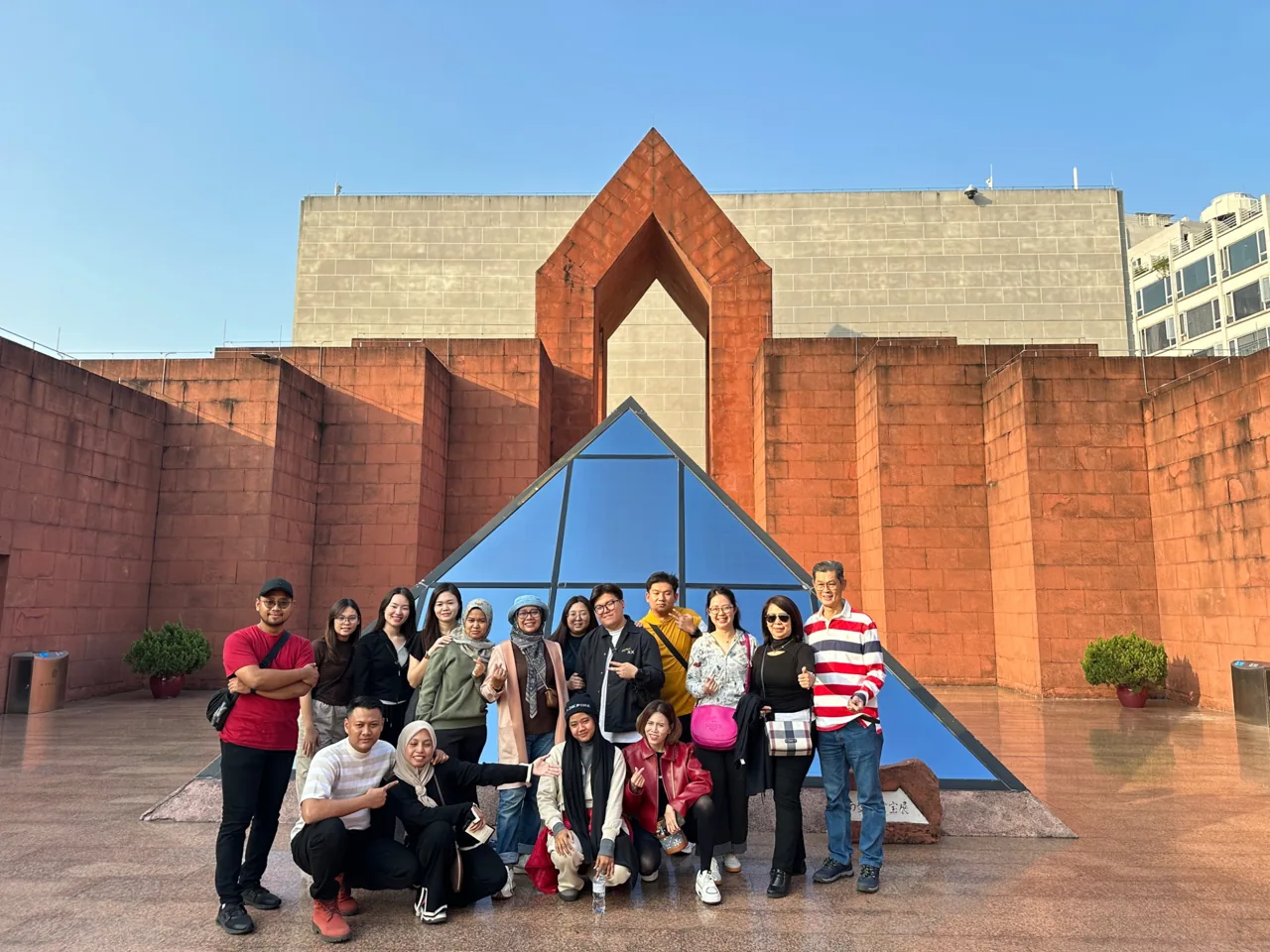 A group posing in front of a museum